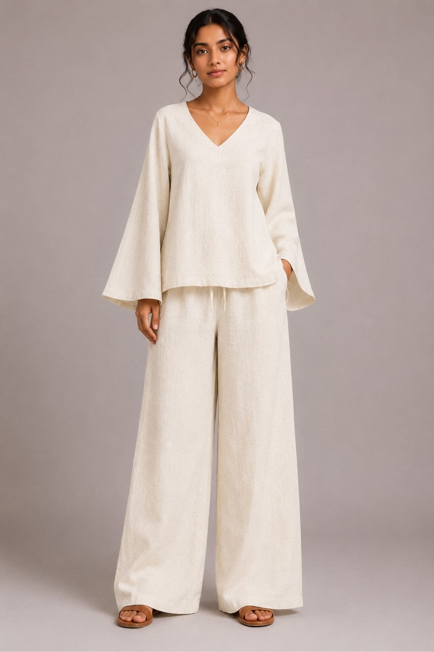 Woman wearing handwoven Khadi co-ord set with V-neck bell sleeve kurti and relaxed pant in plane color
