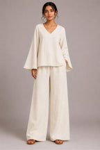 Woman wearing handwoven Khadi co-ord set with V-neck bell sleeve kurti and relaxed pant in plane color